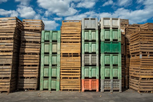 Various materials for building a compost bin, including wooden pallets and plastic containers